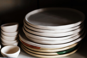 clay cups are dried before being baked and painted in workshop