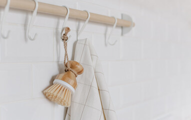 Kitchen railing with bamboo brush and towel. Cleaning concept. Eco style.