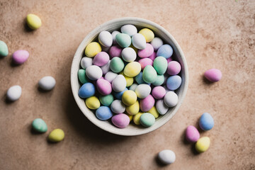 Top view of bowl of colorful mini chocolate eggs for Easter.