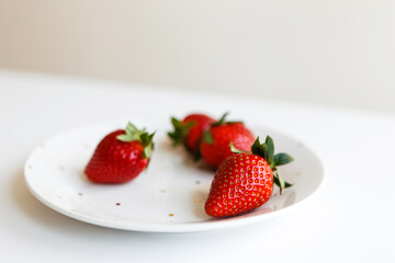 red ripe fresh strawberries on plate in kitchen before making dessert