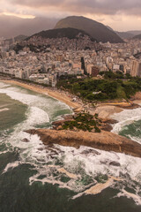 Beautiful aerial view to ocean rocky point in Arpoador and city 