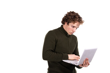 A young attractive man is working on a laptop. Early morning. White background.