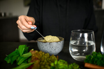 Making healthy green cocktail, in the kitchen