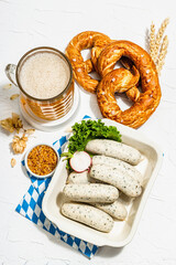 Traditional Oktoberfest set. Pretzels, beer, smoked pork knuckle eisbein with mustard