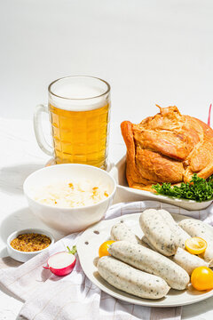 Traditional Oktoberfest set. Beer, weisswurst, smoked pork knuckle eisbein with fermented cabbage