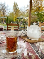 Teapot with tea on the table. Nature  - 591390222