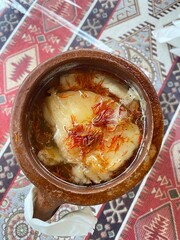 Azerbaijani Sheki piti soup prepared with mutton, tail fat, chickpeas, potato, onions, dried alycha and saffron and cooked in a clay pot - 591390236