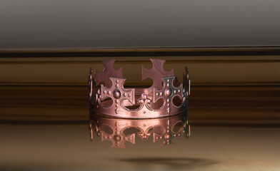 golden crown with precious stones on a golden background