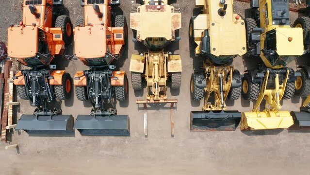 Aerial top down, used construction loaders and industrial machine for sale in a lot
