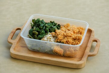 Urap or mix vegetables with grated coconut in plastic box. Indonesian foo