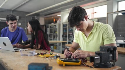 College Student building electronics circuit in the engineering technology course - Digital Innovation in Education