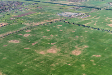 Atmospheric view of a field flat landscape in Ukraine in summer. Drone view of the meadow, road and...