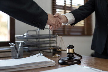 Fototapeta na wymiar Lawyer consultant shaking hand with client in law firm..