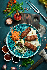 Grilled Lula kebab with onions and pita bread. Azerbaijani cuisine. Free space for text. Close up.