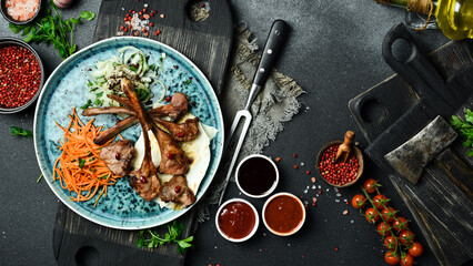 Grilled lamb steak on the bone with onions and pita bread. Barbecue menu. Free space for text. Close up.