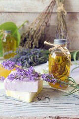 Lavender flowers, soap, oils and tinctures, on a wooden background, natural ingredients, alternative medicine