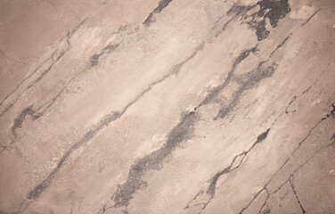 Brown background from decorative plaster with abstract spots. Unusual beige wall texture with beautiful patterns, creative surface background. Front covering for facing of buildings.