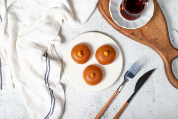 Sekerpare dessert. Turkish Ramadan dessert. Sekerpare dessert with sherbet on a marble serving plate. Top view
