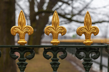 Antique wrought iron fence with gilded ornament