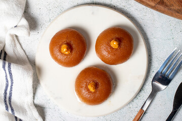 Sekerpare dessert. Turkish Ramadan dessert. Sekerpare dessert with sherbet on a marble serving...