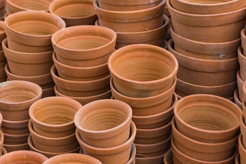 Clay pots or tubs for gardening stacked together. Terracotta pots are essentials for home balcony gardens. Product from pottery industry.