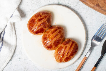 Sekerpare or bademdpare dessert. Turkish Ramadan dessert. Şekerpare dessert with sherbet on a...
