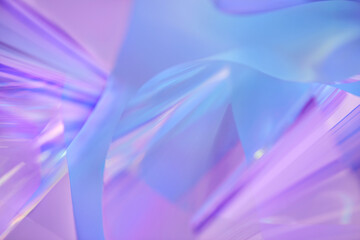 Close-up of ethereal pastel neon blue, purple, lavender, mint holographic metallic foil background. Abstract modern curved blurred surreal futuristic disco, rave, techno, festive dreamlike backdrop
