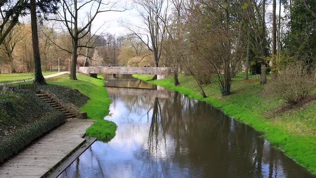 View of the bridge early spring on the river Utrata in the park in Zelazowa Wola, the birthplace of the famous composer Fryderyk Chopin.