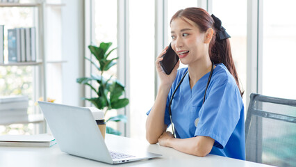 Asian young beautiful professional successful female doctor in blue uniform with stethoscope...