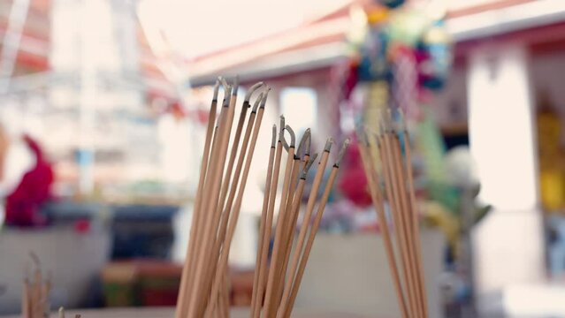4K, Slow, Close-up many incense sticks praying pray for holy, in holy place that is for praying making merit for those who respect and is belief one group, smoke came out incense sticks lew by wind.