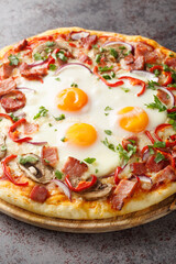 Aussie pizza topped with a base of barbecue sauce, mozzarella cheese, bits of chopped bacon, eggs, peppers and mushrooms closeup on the table. Vertical