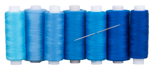 Many spools with blue thread and needle for sewing, supply for sewing, isolated objects 
