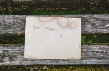 Vintage paper on the old weathered wooden background