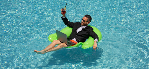 Funny business man in suit drink summer cocktail and using laptop on the sea beach. Summer holiday,...