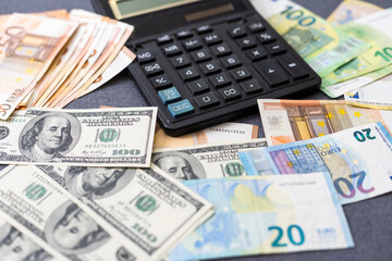 Euro and dollar notes. euro against dollar. A closer look of the president of the USA with a dollar bill, peeping out from behind a euro bill. USA and Europe finance relation. Close up top view.