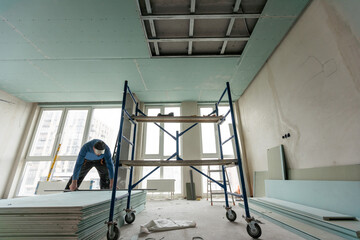 Construction worker installation ceiling work
