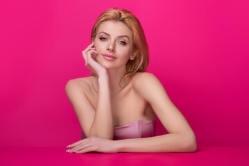 Naklejka premium Beauty face of young blonde woman. Sexy model posing in studio. Portrait of beautiful girl. Beauty woman face closeup. Pretty girl face on studio background. Sensual look. Beautiful female face.