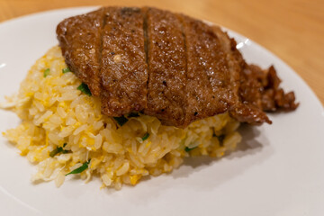 Close-up view of the pork chop egg fried rice on the plate.