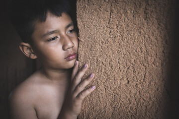 Portrait of a poor little thailand boy lost in deep thoughts, poverty, Poor children, War refugees,...