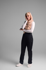 Fototapeta premium Woman in casual clothes and hijab standing in the studio