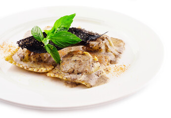 Ravioli in creamy truffle sauce on plate