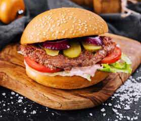 Close-up of home made burger on wooden tray