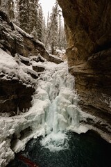Vertial shot of a frozen waterfall in Johnston Canyon on a cold winter day, Banff, Canada