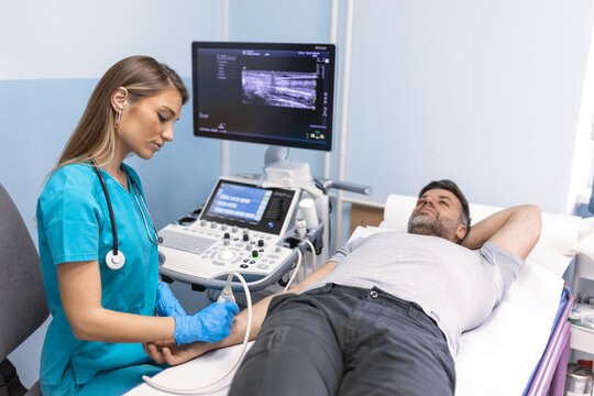 Doctor check ultrasound of patient arm in a clinic for medical and healthcare research at a hospital. Man consulting with surgery professional. Ultrasound of the veins of the upper xtremities concept