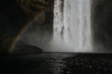 Beautiful view of a rainbow against a waterfall