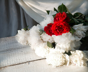 Fototapeta premium Bouquet of peonies on a table in the garden