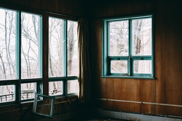 Fototapeta premium Interior of an abandoned building with broken windows