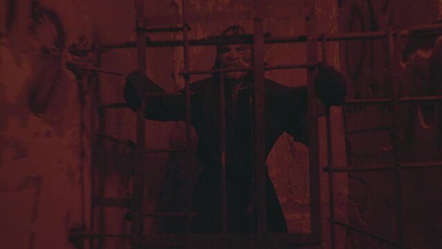 The killer or the executioner in the jail cell. Horror scene for halloween. High quality FullHD footage.