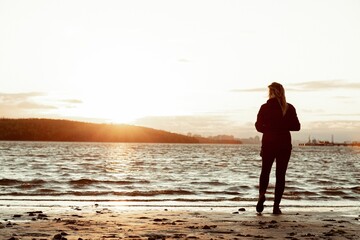 a person standing on top of a sandy beach near the ocean