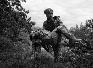 The commander carries a wounded soldier